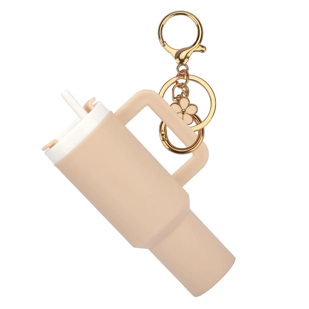 Beige keychain with gold accents on a white background