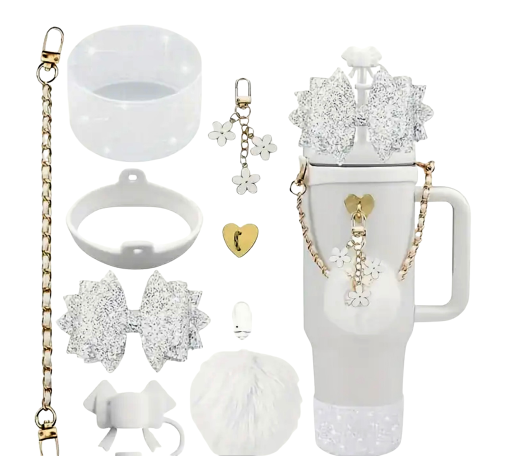 Collection of white and gold accessories including a mug, keychain, and decorative items on a white background.