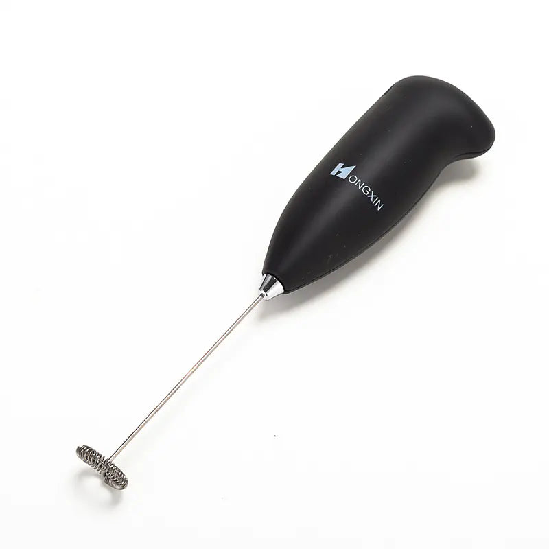 Black milk frother with metal whisk on a white background