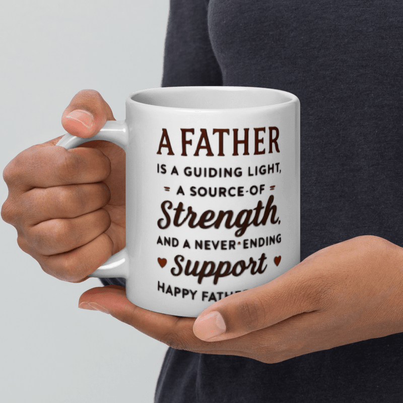 Person holding a mug with a Father's Day message on a light gray background