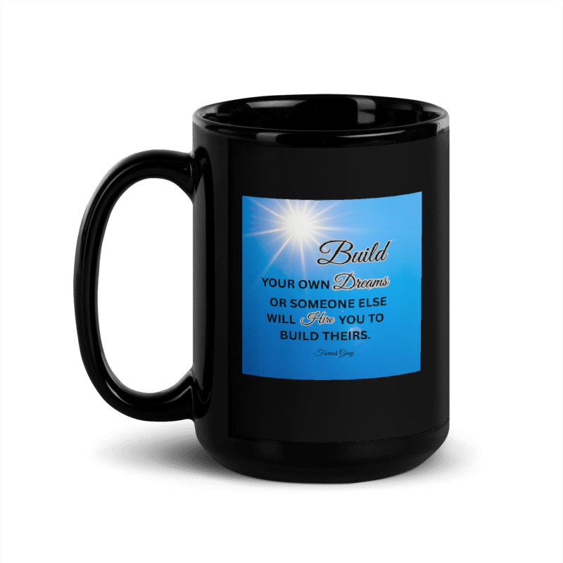 A glossy black ceramic mug with a blue motivational quote printed on the front.