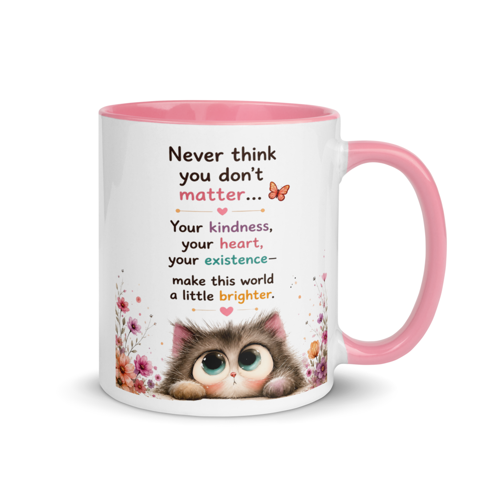 A white ceramic mug with a pink interior and handle, featuring a cute cartoon kitten illustration and a supportive quote printed on the front.