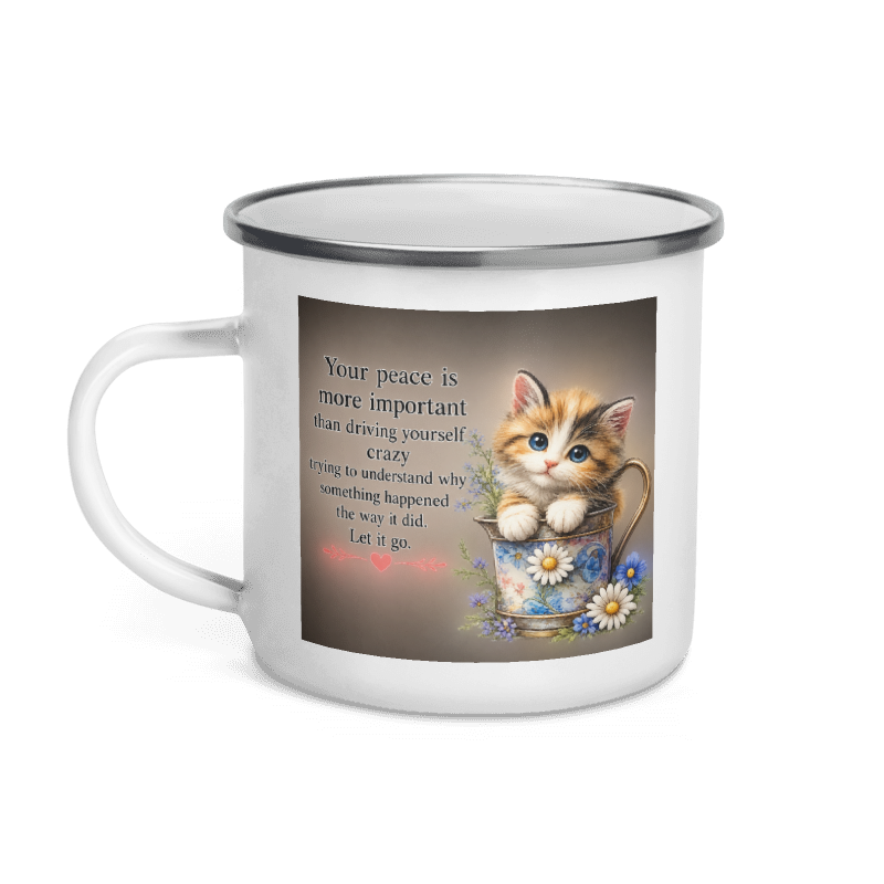 A white enamel-style mug with a silver rim, featuring a printed graphic of a cute orange tabby kitten sitting in a floral teacup next to a quote 