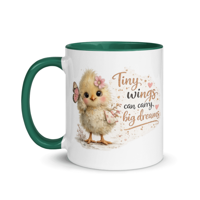A white ceramic mug with a dark green handle and interior, featuring a cute illustration of a fluffy yellow chick with a pink flower in its feathers, holding a butterfly. To the right of the chick is the printed quote 'Tiny wings can carry big dreams' in brown and black lettering.
