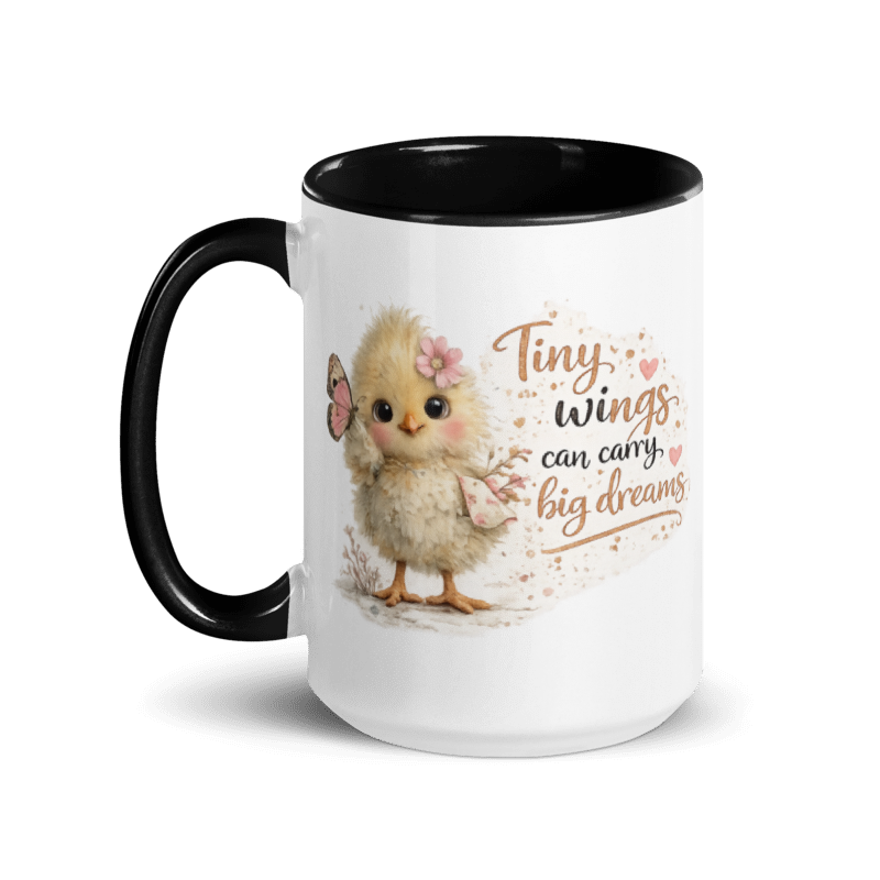 A white ceramic mug with a black handle and black interior, featuring a cute illustration of a fluffy yellow chick with a pink bow and the text 'Tiny wings can carry big dreams' on the front.