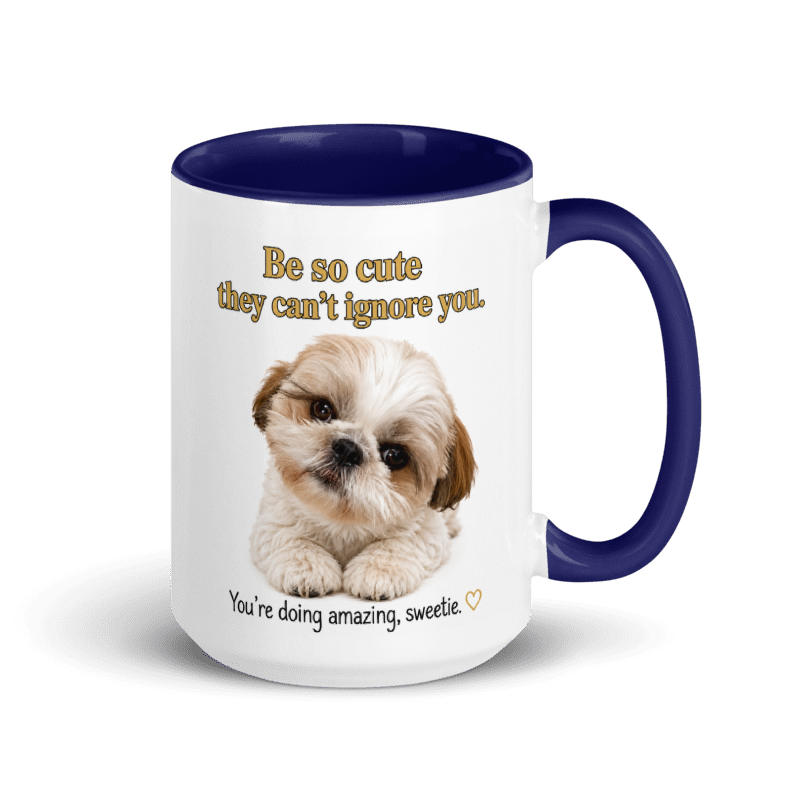 A white ceramic mug with a dark blue interior, handle, and rim, featuring a cute Shih Tzu puppy photo and the text 'Be so cute they can't ignore you.' and 'You're doing amazing, sweetie'.