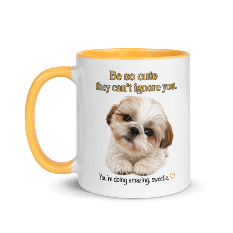 A white ceramic mug with a yellow handle and interior, featuring a cute Shih Tzu puppy photo and the text 'Be so cute they can't ignore you.' and 'You're doing amazing, sweetie.
