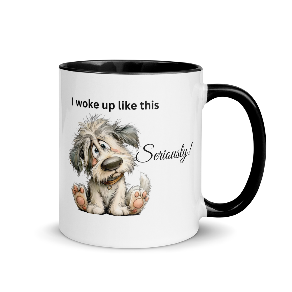 A white ceramic coffee mug with a black interior and black handle, featuring a cartoon illustration of a scruffy dog and the text 'I woke up like this Seriously!'.