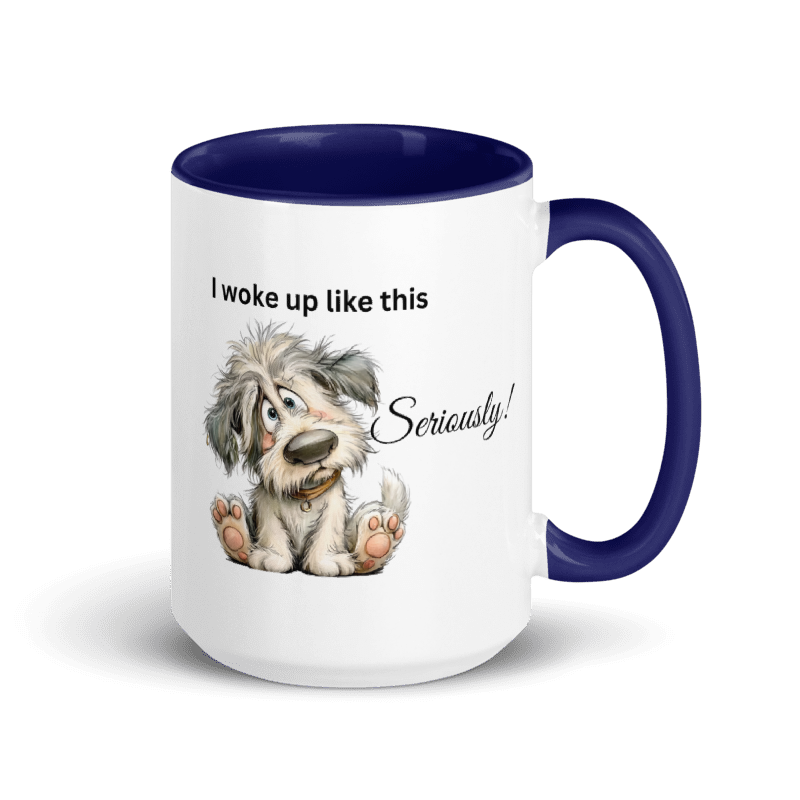 A white ceramic mug with a dark navy blue interior, handle, and rim, featuring a cartoon illustration of a fluffy gray and white dog sitting down with the text 'I woke up like this Seriously!' printed on the side.