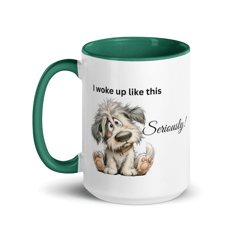 A white ceramic mug with a dark green handle and interior, featuring a cartoon illustration of a fluffy gray and white puppy sitting with the text 'I woke up like this Seriously!' printed on the front.