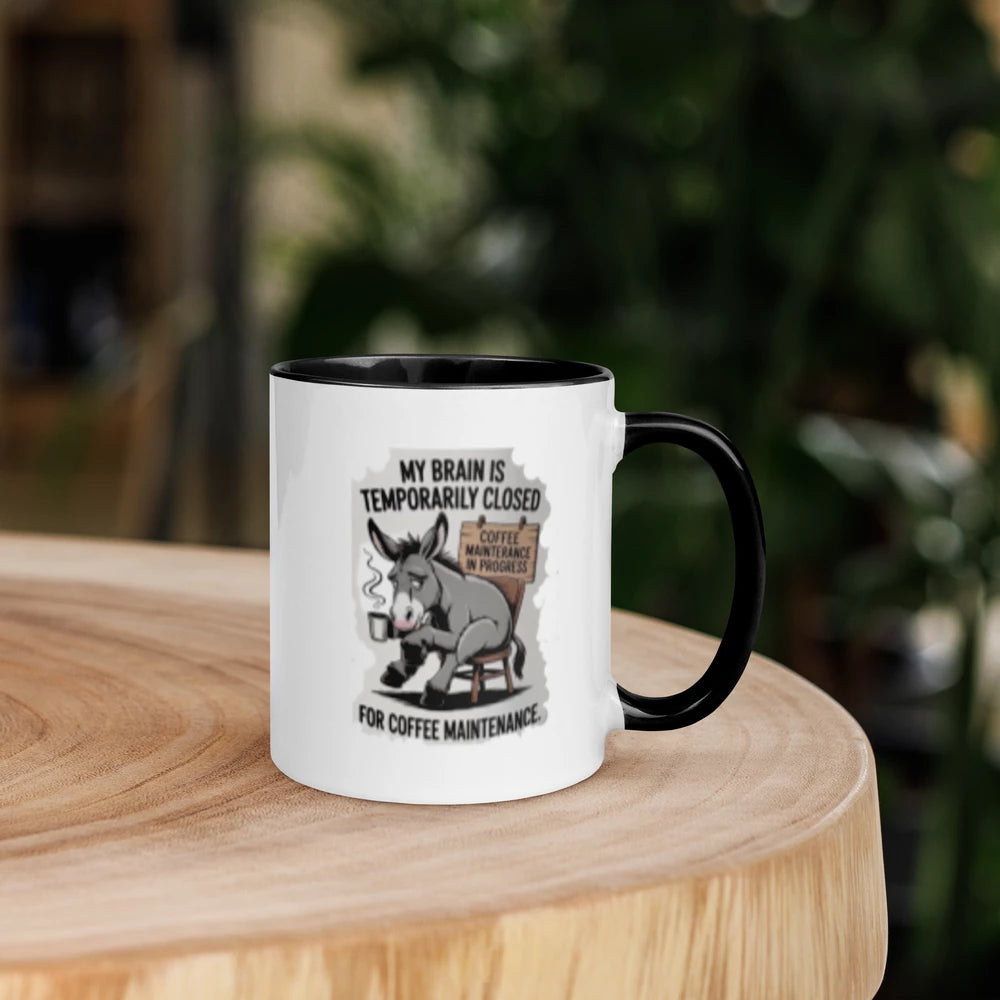 Mug with a donkey graphic and text on a wooden surface with a blurred background