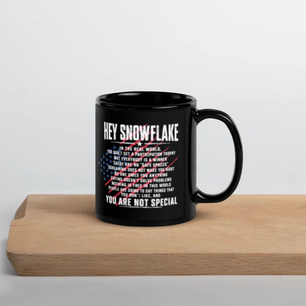 Black mug with text and American flag design on a wooden surface
