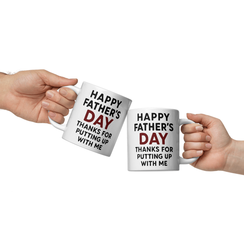 Two white mugs with 'Happy Father's Day' text held by two hands on a white background