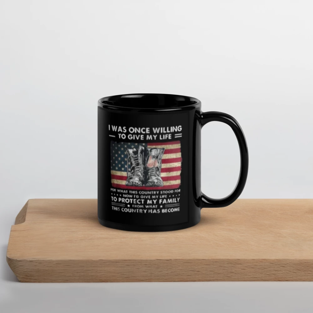 Black mug with a patriotic design on a wooden surface