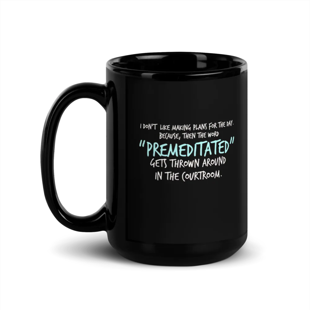 Black mug with white humorous text on a white background