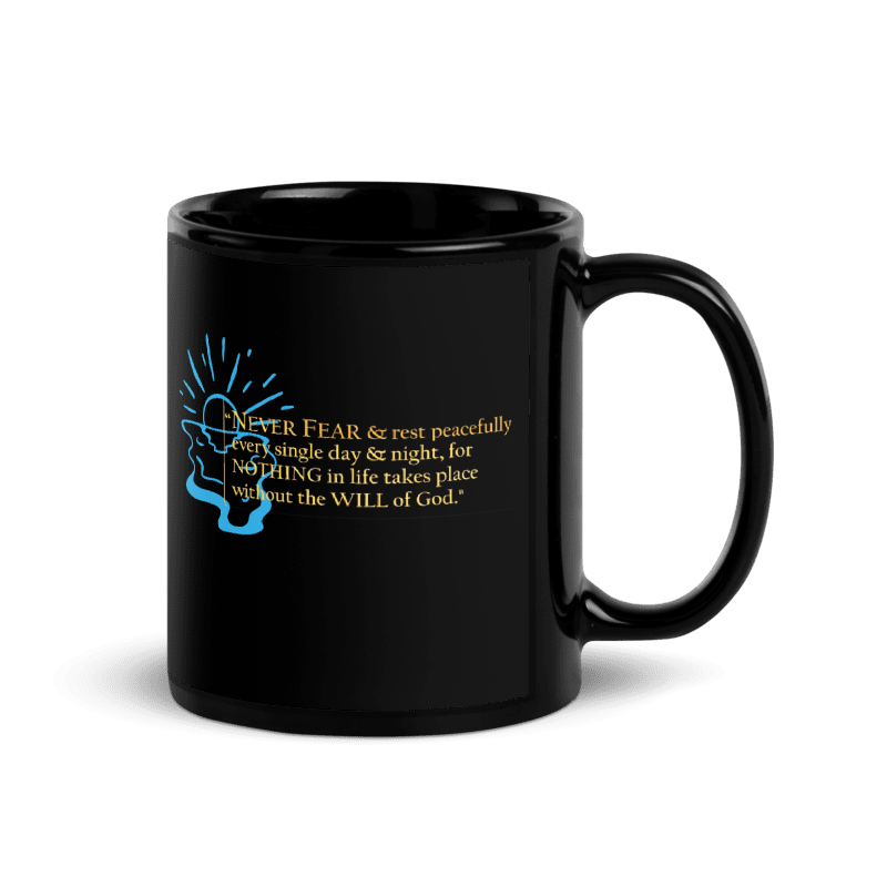 A glossy black ceramic mug with a printed graphic on the side featuring a blue silhouette of a hand holding a glowing Bible and gold text that reads, 'I NEVER FEAR & rest peacefully in a single day & night, for NOTHING in life takes place without the WILL of God.'.