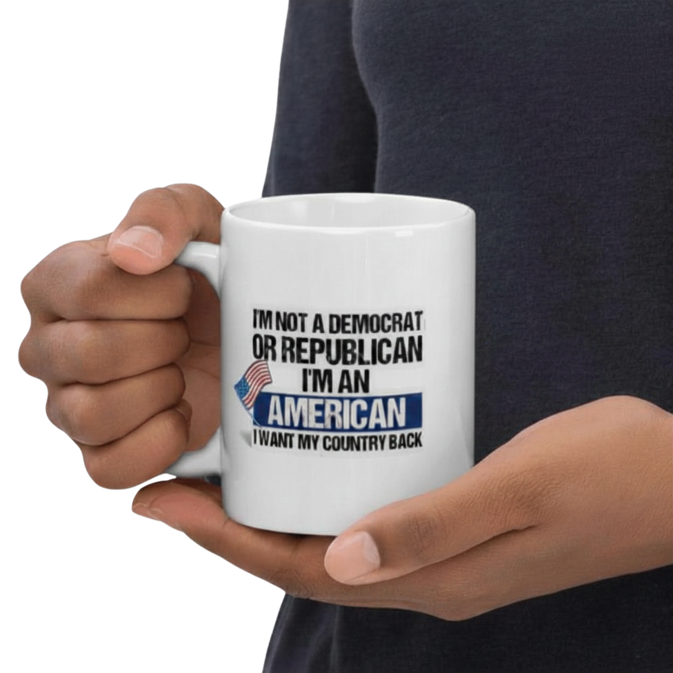 Person holding a rt. handed 11oz white mug with a political message - I'm American