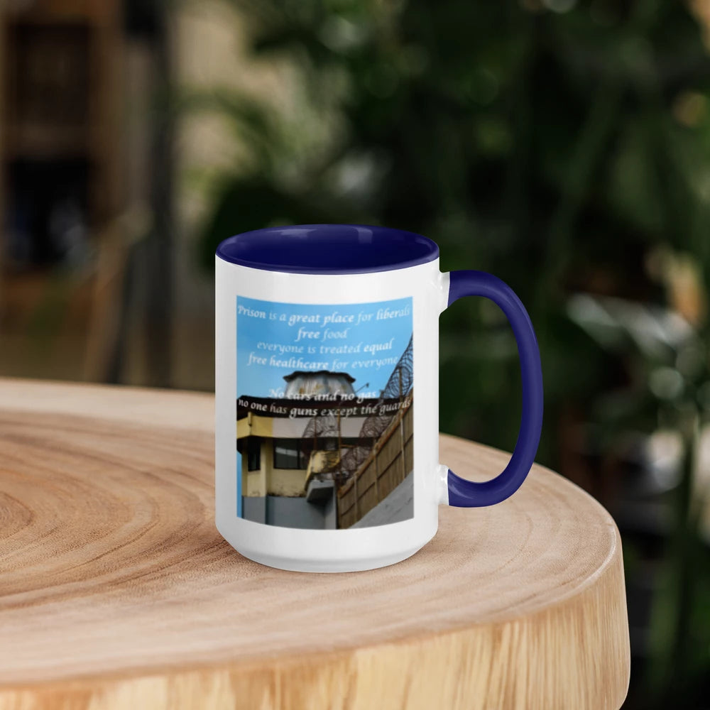 Mug with blue interior and handle on a wooden table, featuring a printed design.