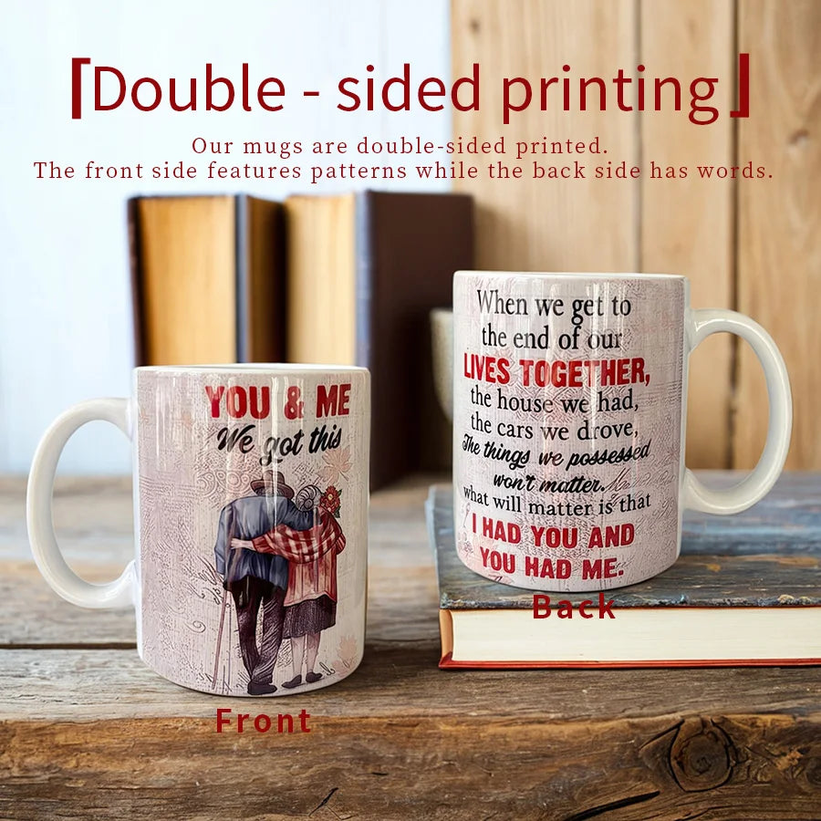 Two mugs OF A COUPLE with double-sided designs on a wooden surface with books in the background.