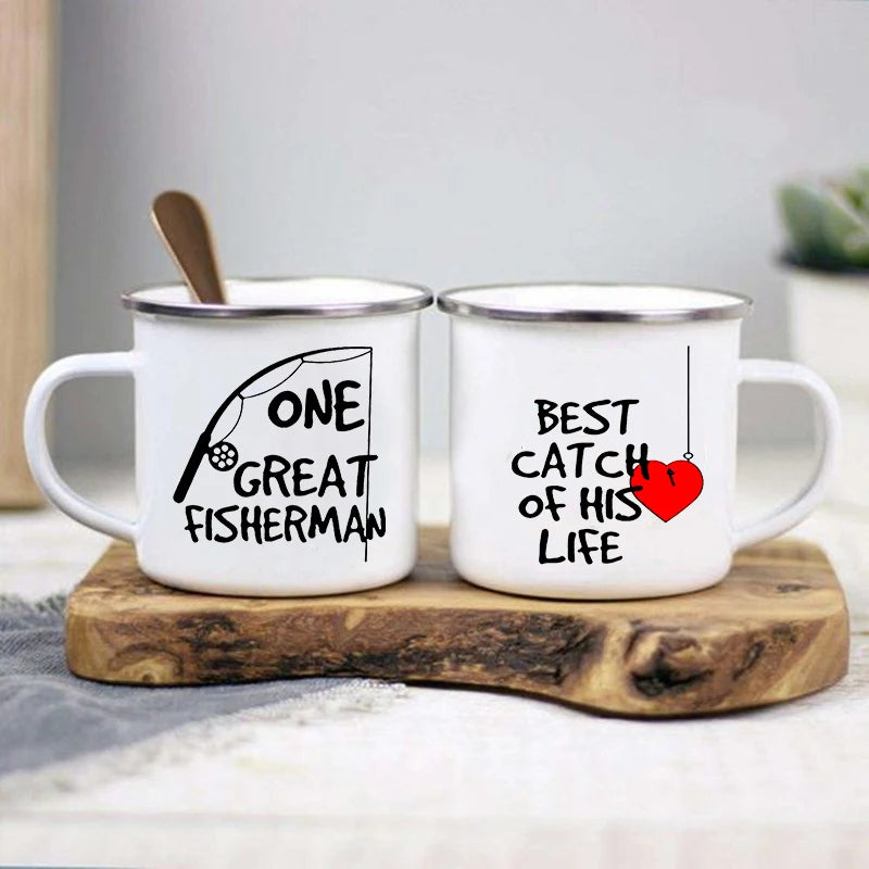 Two white mugs with fishing-themed text on a wooden coaster.
