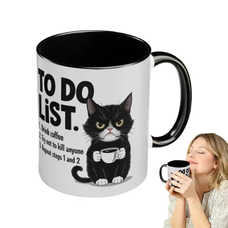 Mug with a cat illustration and text, held by a person on a white background