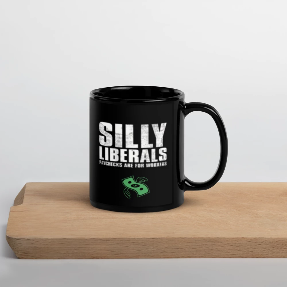 Black mug with 'SILLY LIBERALS' text on a wooden surface