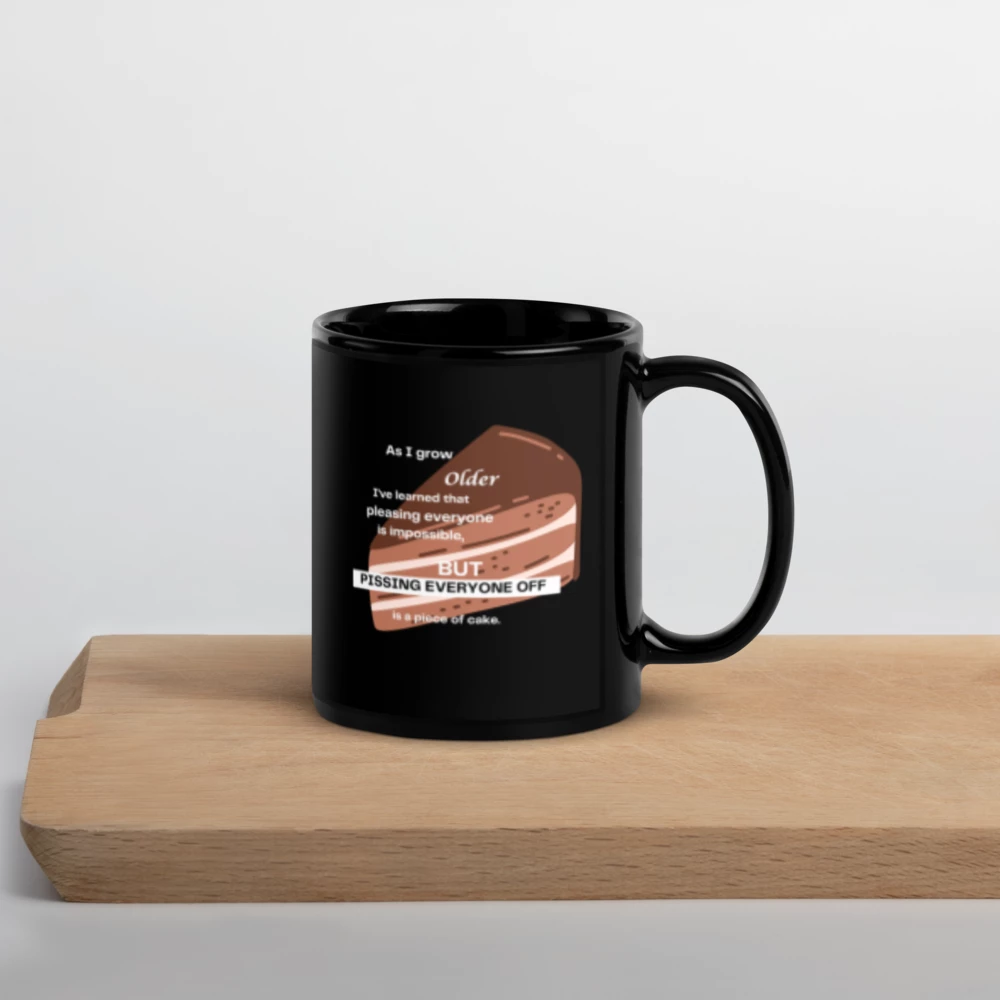 Black mug with a humorous design on a wooden surface