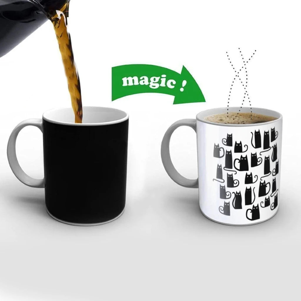 Black mug being filled with coffee next to a white mug with black cat patterns, labeled 'magic'.