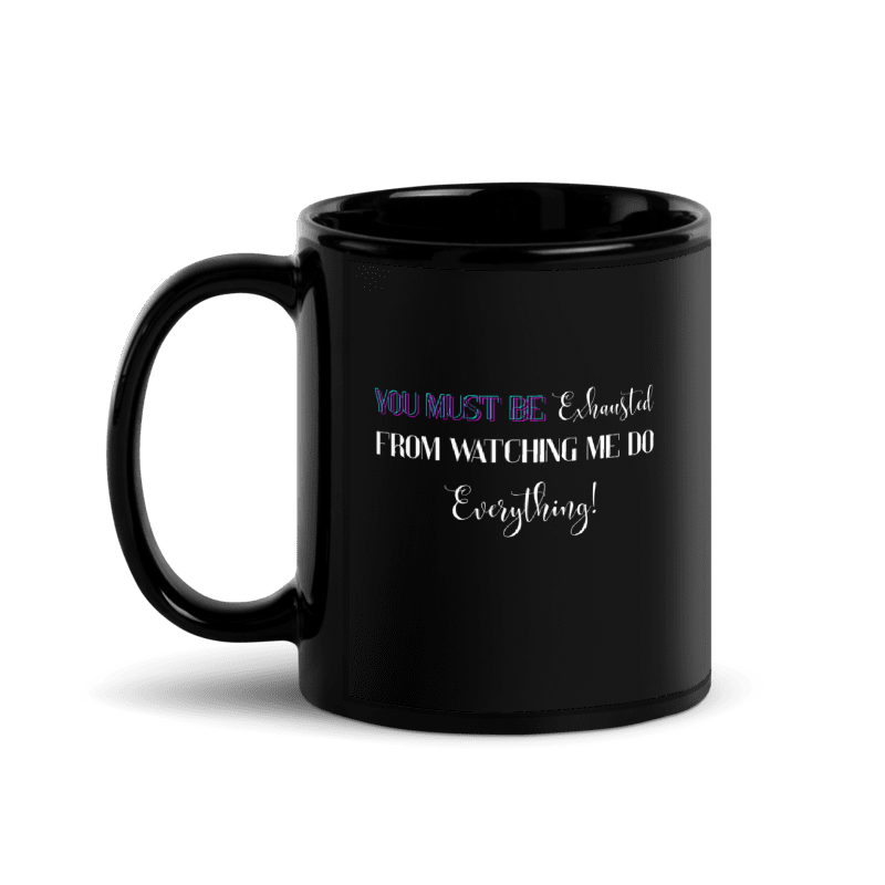 A black ceramic mug with a handle on the left, featuring the text 'YOU MUST BE Exhausted FROM WATCHING ME DO Everything!' in white and purple lettering