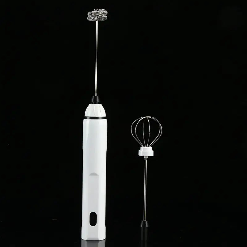 White handheld frother with whisk attachment on a black background